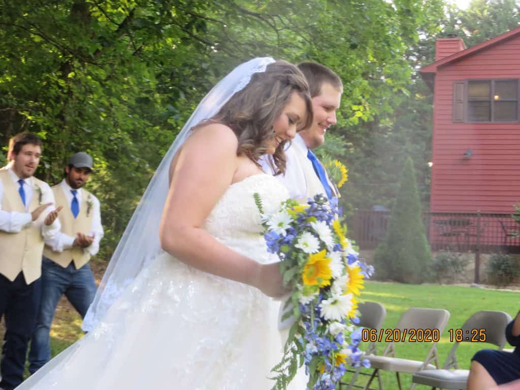 Wedding couple at Tanglewood Cabin Rental, outdoor ceremony setting.